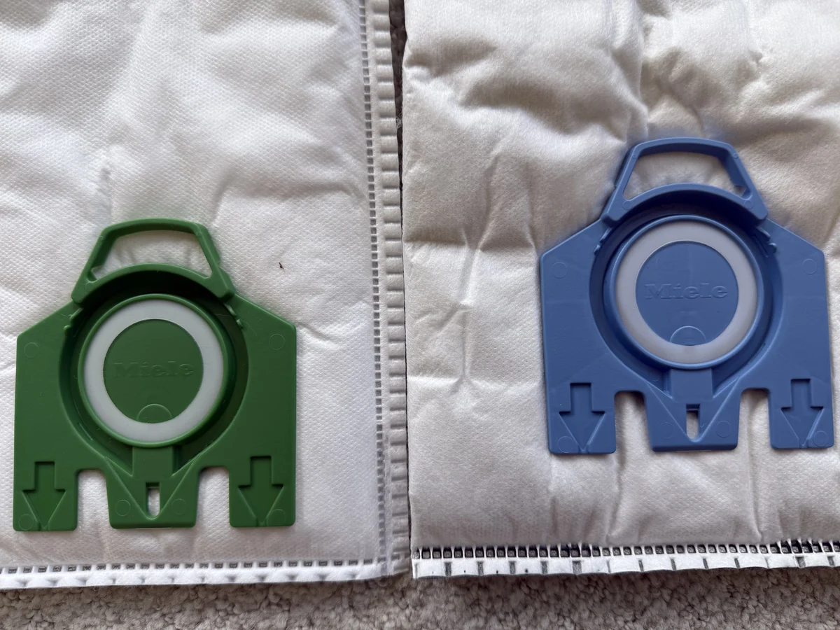Miele Type U green collar beside Miele GN blue collar showing upright versus canister bag fitment